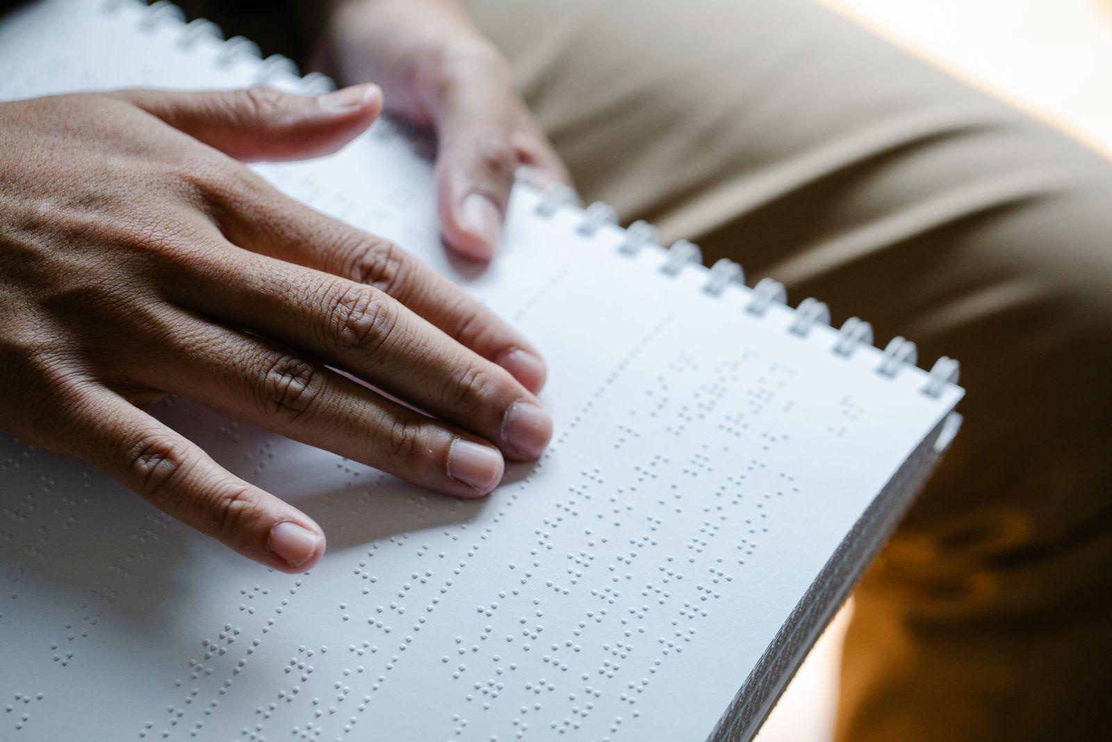 Reader accessing a document through braille — accessibility means every reader