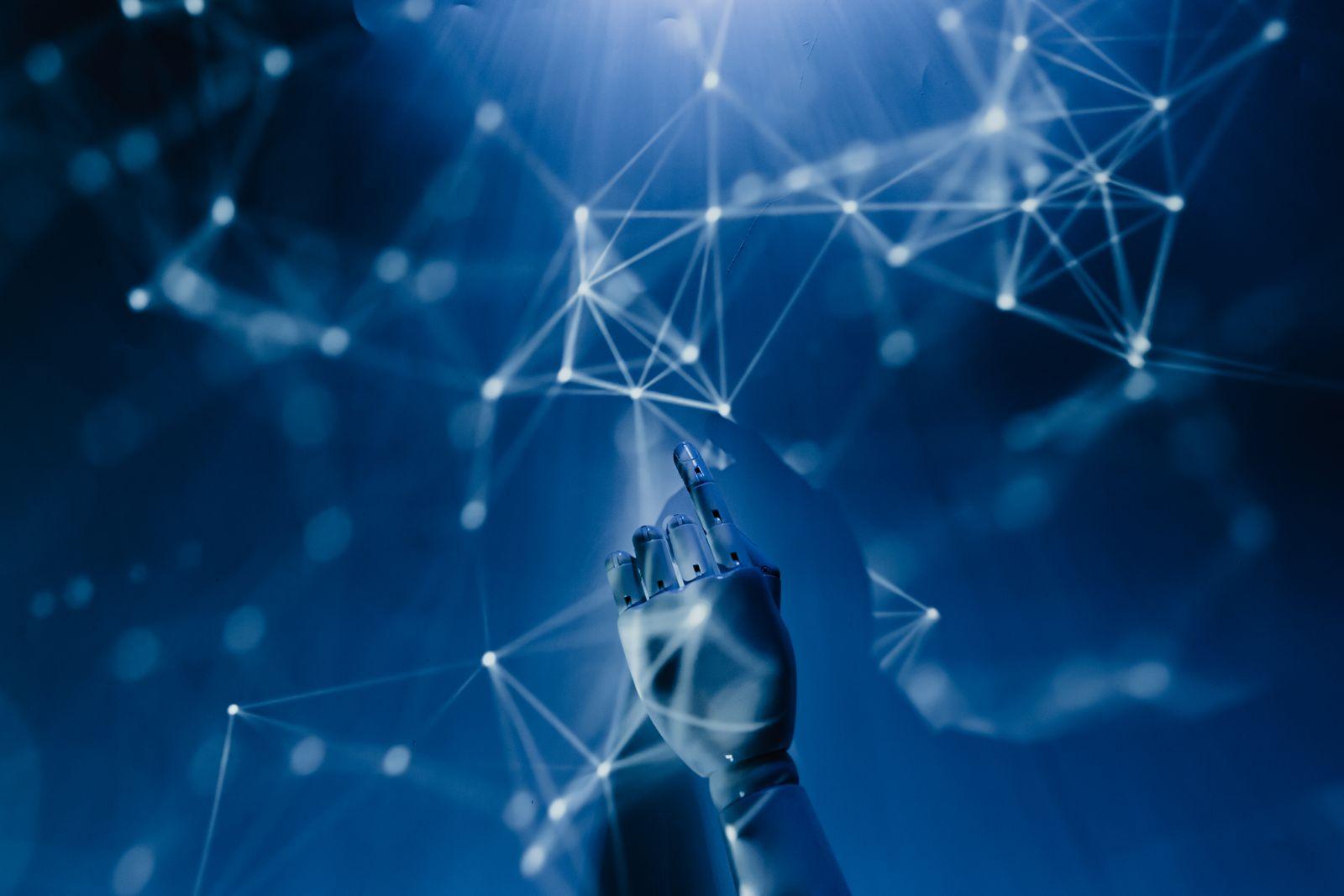 Robotic hand reaching into a connected digital network