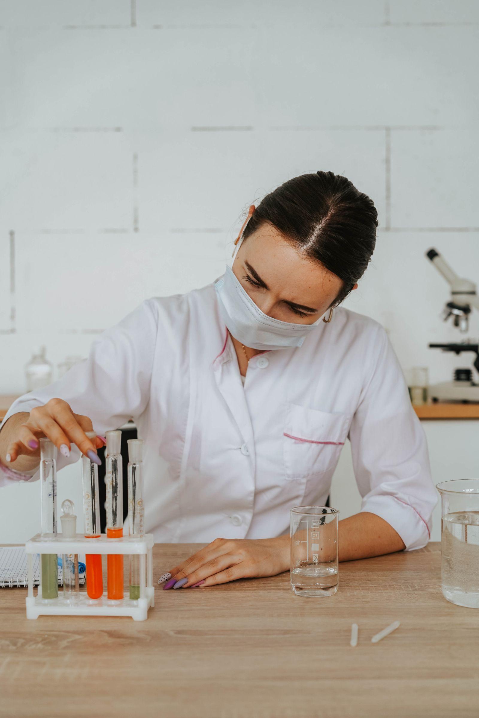 Scientist in gloves examining test tubes in a research laboratory