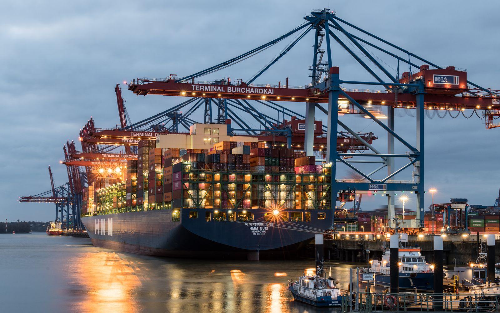 Container ship loading at a European port terminal, representing US goods entering the EU market under PPWR