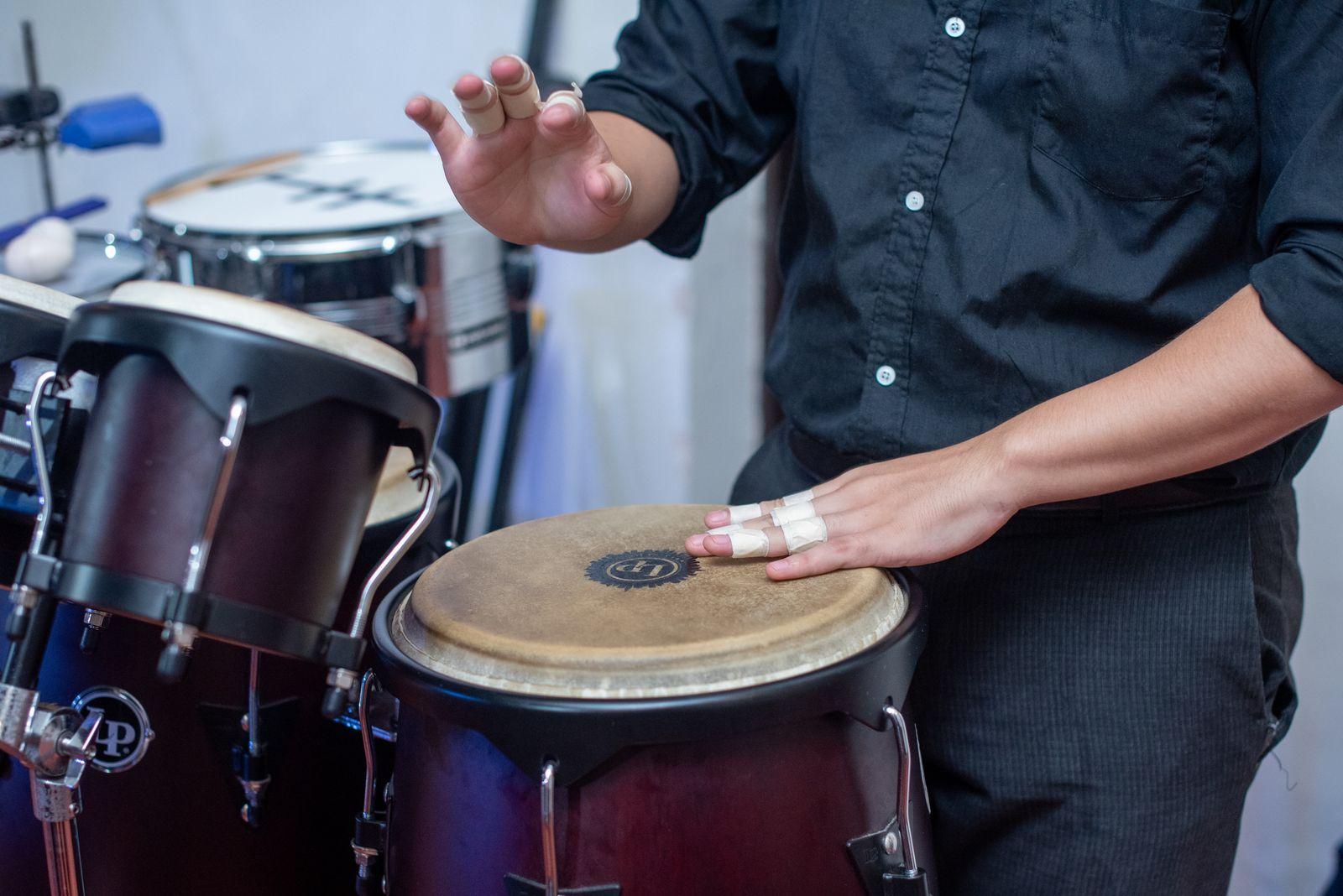 Close-up of hands playing conga drums — Afro-Caribbean hand-drumming.