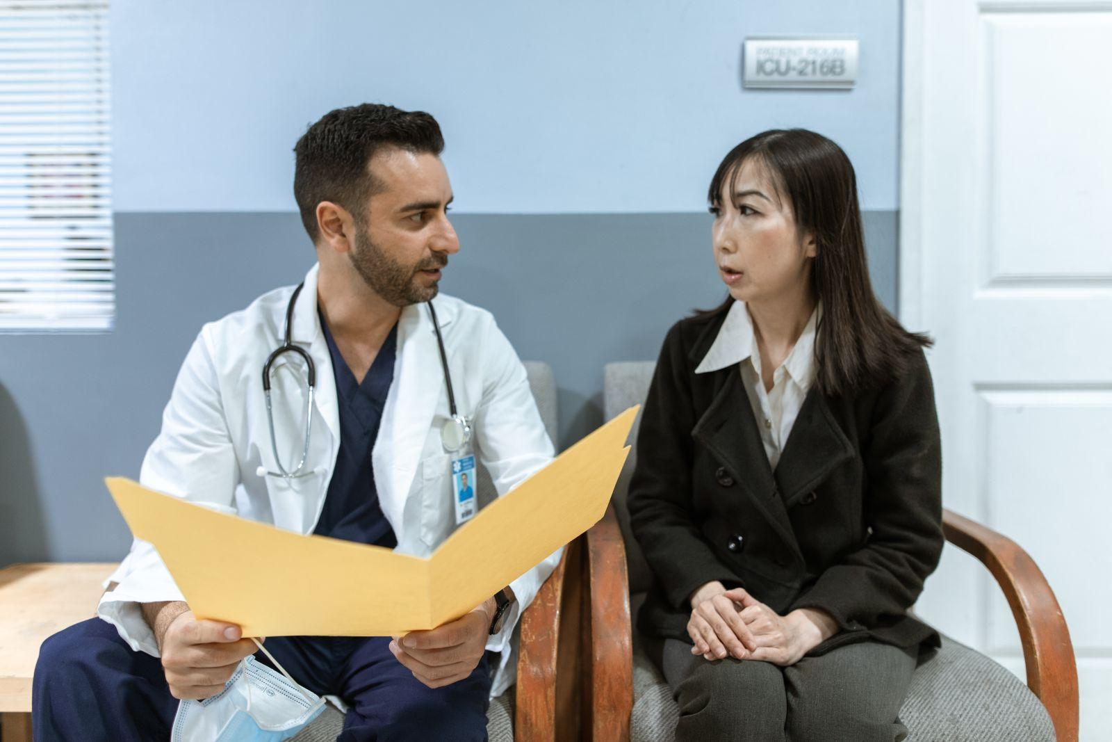 Healthcare professional consulting with a patient in a clinical setting