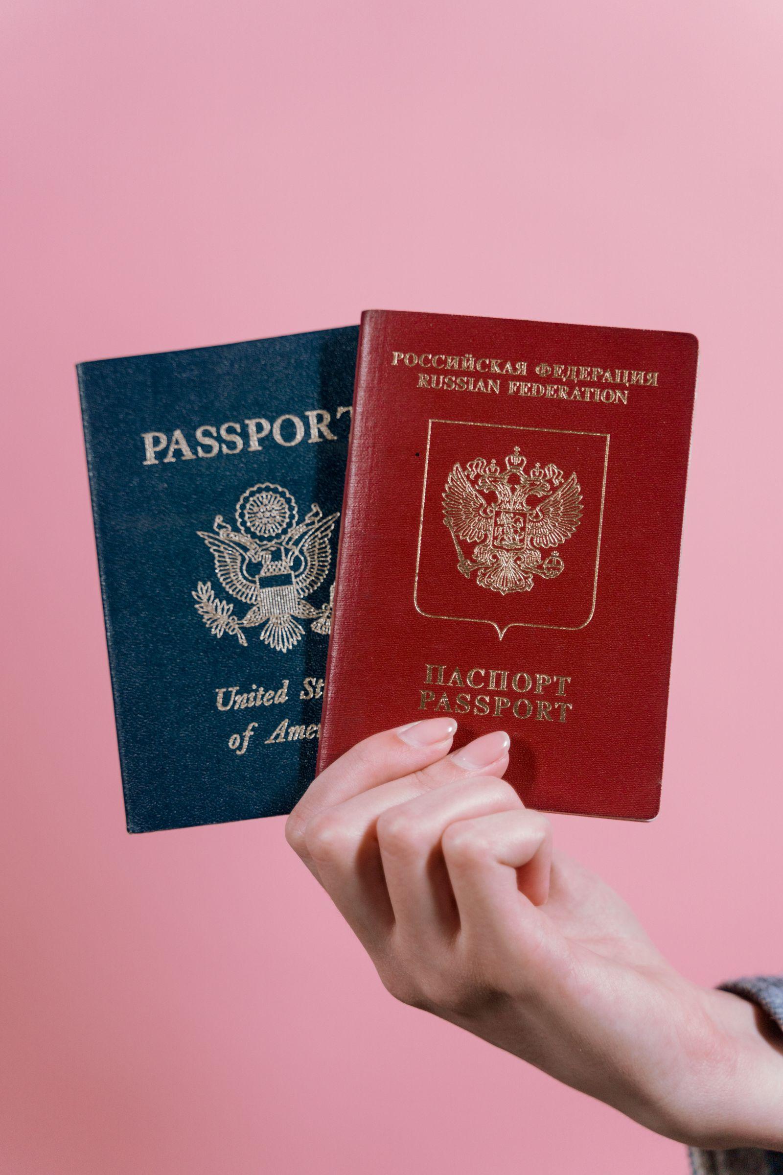Two passports held together — documents from two countries, one immigration case