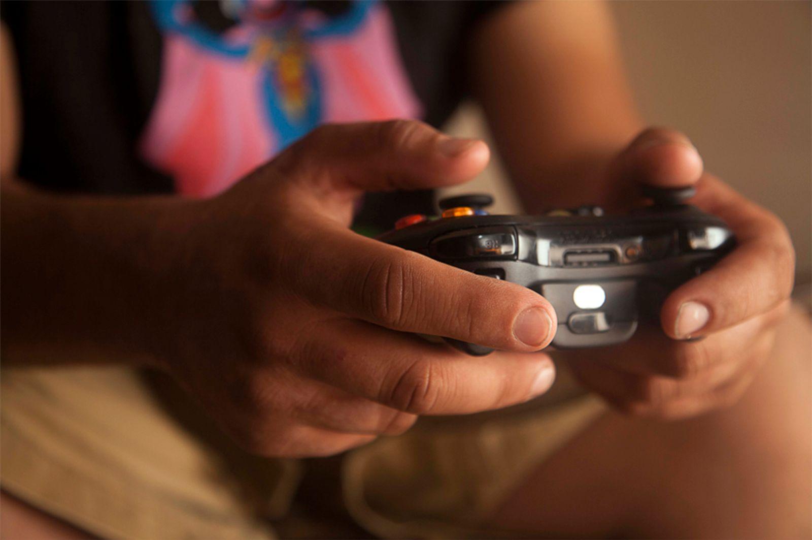 Person holding a game controller mid-session